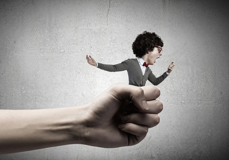 Funny young man with big head screaming emotional in mobile phoneの写真素材