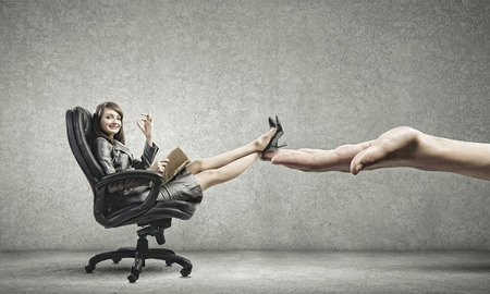 Young attractive businesswoman reading book in chairの写真素材