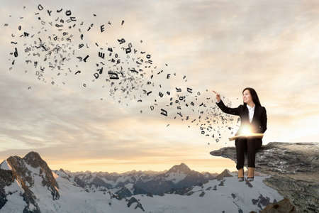 Young pretty lady with book in handsの写真素材
