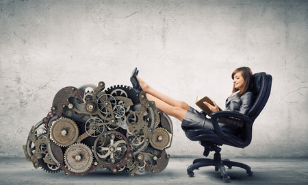 Young attractive businesswoman reading book in chairの写真素材