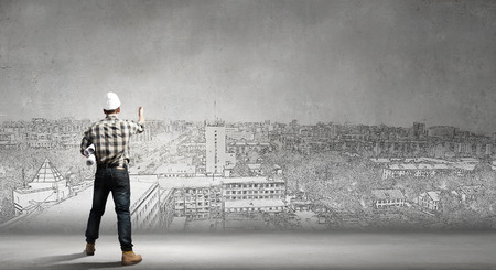 Young man engineer with paper documents in handsの写真素材