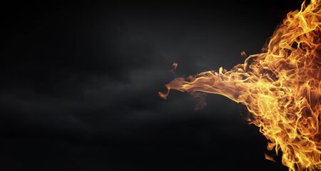Conceptual image of burning fire on dark backgroundの写真素材