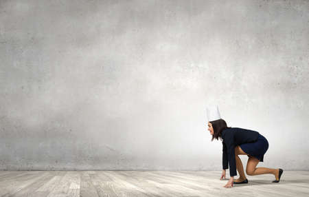 Young businesswoman in paper crown running in a hurryの写真素材