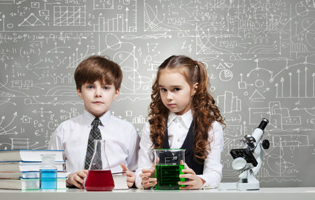 Two cute children at chemistry lesson making experimentsの写真素材