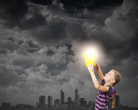 Cute girl with bucket and light bulb in itの写真素材