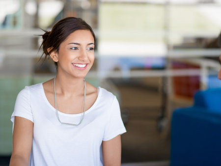 Happy and confident young woman in an office
