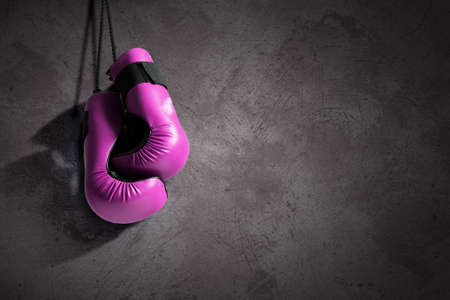 Pair of boxing gloves hanging on allの写真素材