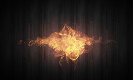 Conceptual image of burning fire on dark backgroundの写真素材