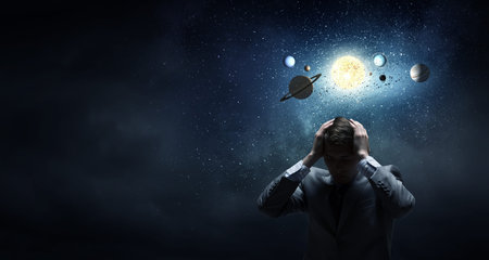 Young businessman and planets of space spinning around