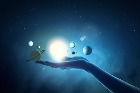 Close up of human hand with planet of sun systemの写真素材