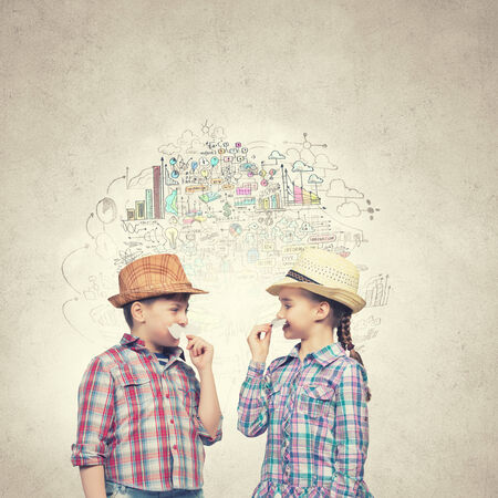 Cute girl and boy wearing shirt hat and mustacheの写真素材