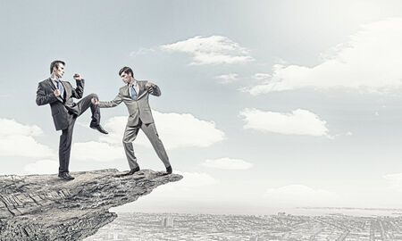 Two furious businessman fighting with each otherの写真素材