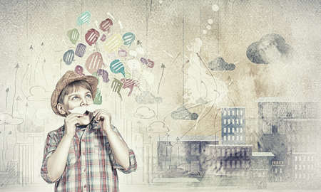 Funny cute boy trying on paper mustacheの写真素材