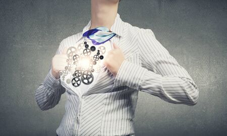 Young woman tearing shirt on chest. Mechanism conceptの写真素材