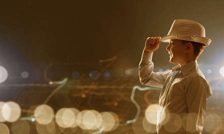 Cute boy of school age against bokeh backgroundの写真素材