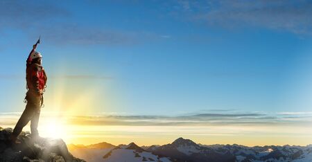 Mountaineer at peak of mountain enjoying natural landscapeの写真素材