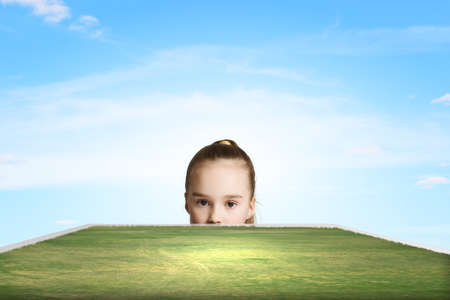 Little cute girl looking at shining sunの写真素材