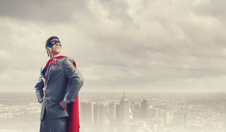Young confident super businessman in mask and cape