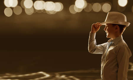 Cute boy of school age against bokeh backgroundの写真素材