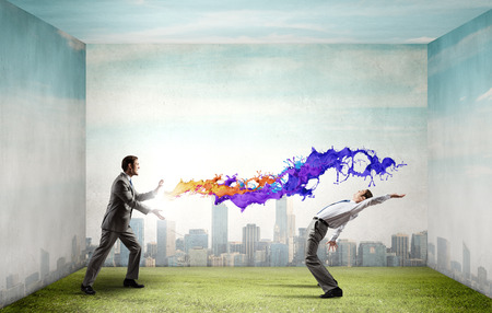 Two business people fighting with each otherの写真素材