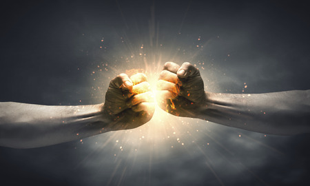 One hand preventing punch attack of another handの写真素材