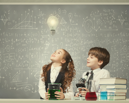Cute girl and boy at chemistry lesson making testsの写真素材