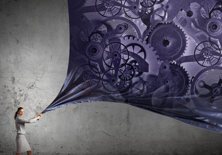 Businesswoman pulling peace of fabric with gears