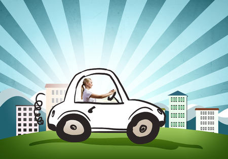 Young girl driving drawn little funny carの写真素材