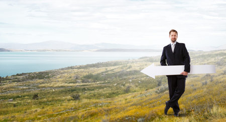 Businessman in suit with white blank arrow in hands