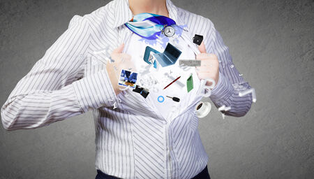 Unrecognizable businesswoman opening her shirt like superheroの写真素材