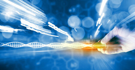 Close up of scientist hand holding tube with leafの写真素材