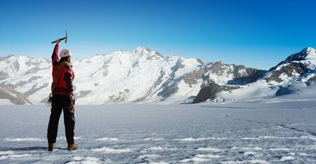 Mountaineer at peak of mountain enjoying natural landscapeの写真素材