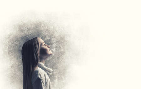 Side view of cute screaming girl against dark backgroundの写真素材