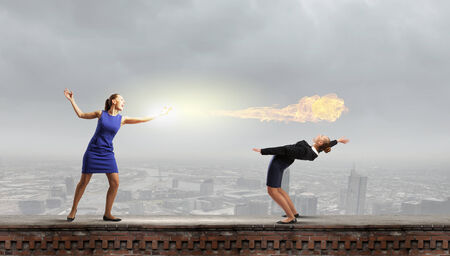 Two business people fighting with each otherの写真素材