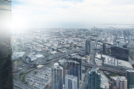 Top view of modern city in lights of sunsetの写真素材