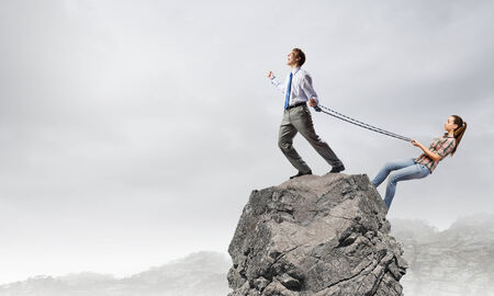 Young man on lead of woman trying to escapeの写真素材