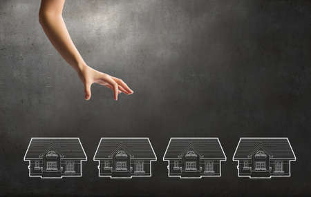 Close up of human hand taking model of houseの写真素材