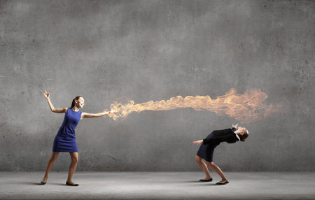 Two business people fighting with each otherの写真素材