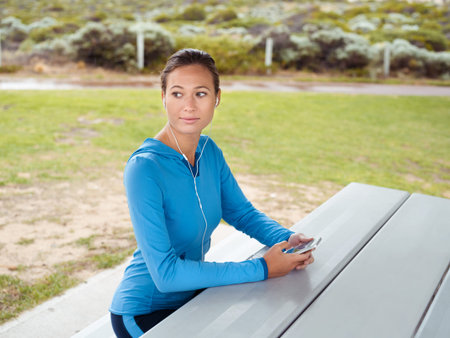 Sporty young woman with a phone and earphones