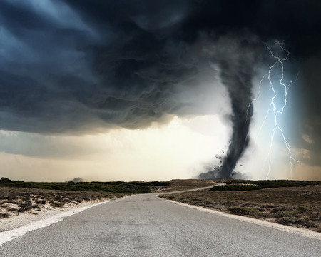 Powerful tornado and lightning above countryside roadの写真素材