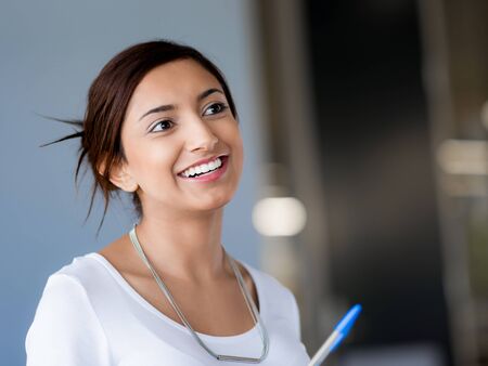 Happy and confident young woman in an officeの写真素材