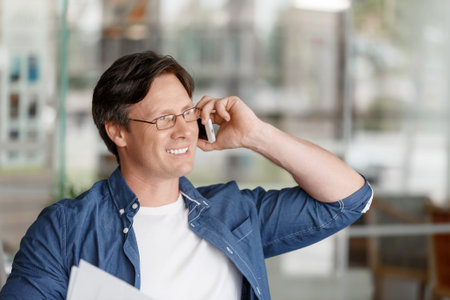 Handsome young businessman talking over phone