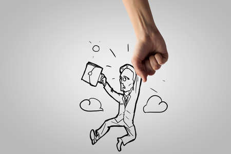 Close up of human hand catching businessmanの写真素材