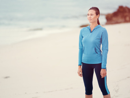 Sporty young woman on the sea coastの写真素材