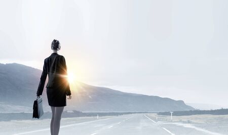 Rear view of businesswoman looking at sunsetの写真素材