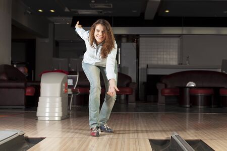 Young pretty woman throwing a bowling ballの写真素材