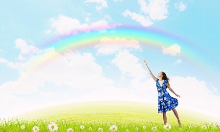 Happy young woman dreaming to fly in skyの写真素材