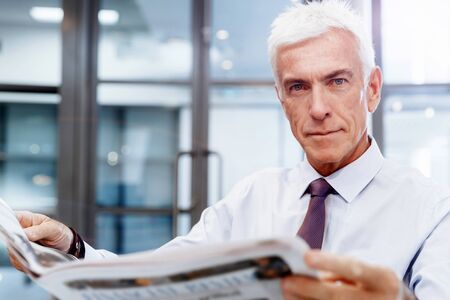 Businessman in office playing chessの写真素材