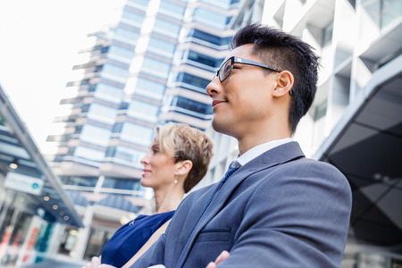 Business team members standing next to each other in business districtの写真素材