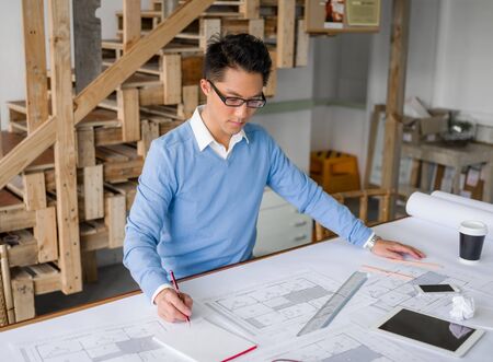 Young chineese engineer working in officeの写真素材